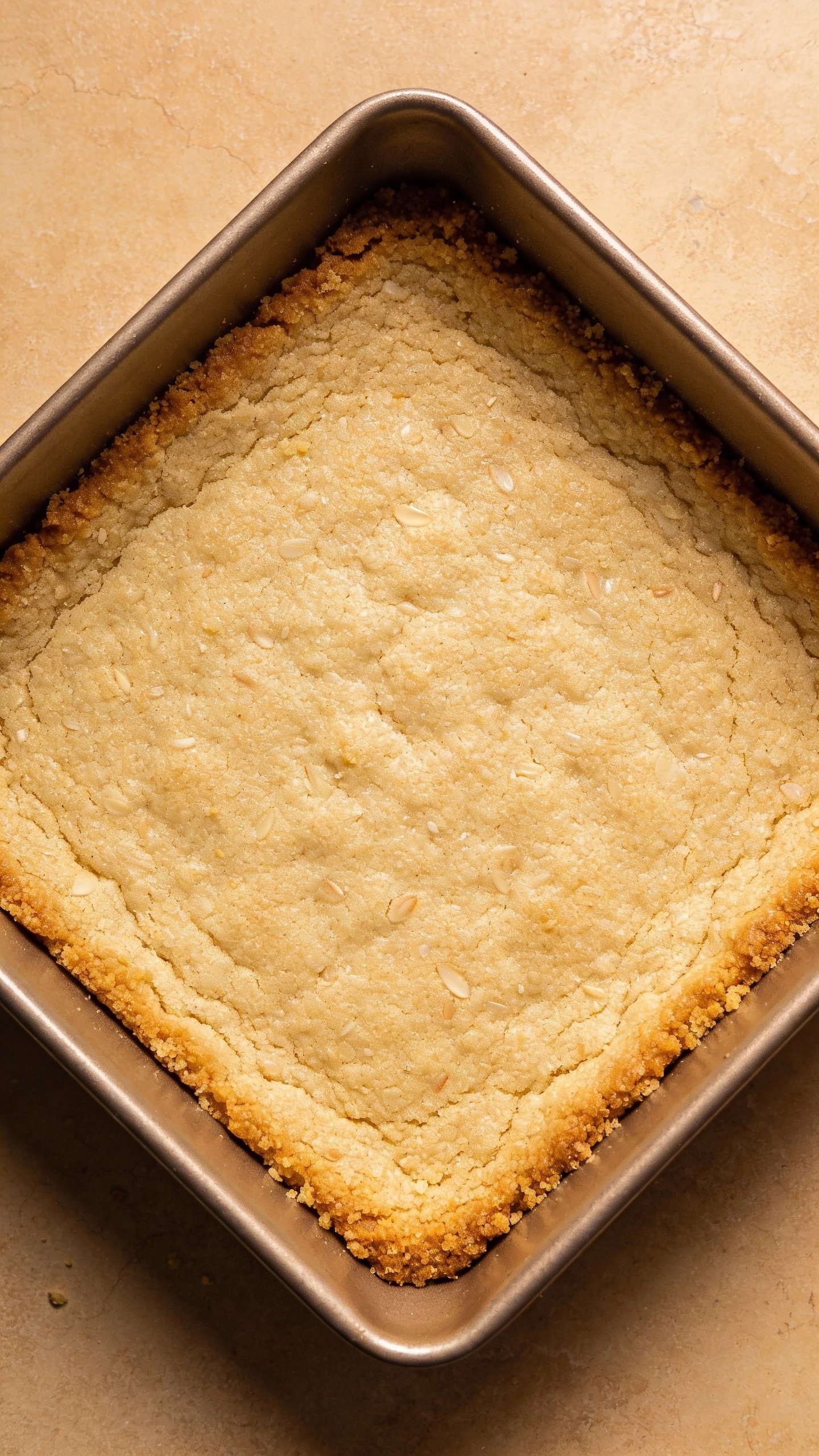 buttery almond-flour shortbread crust in square pan, overhead