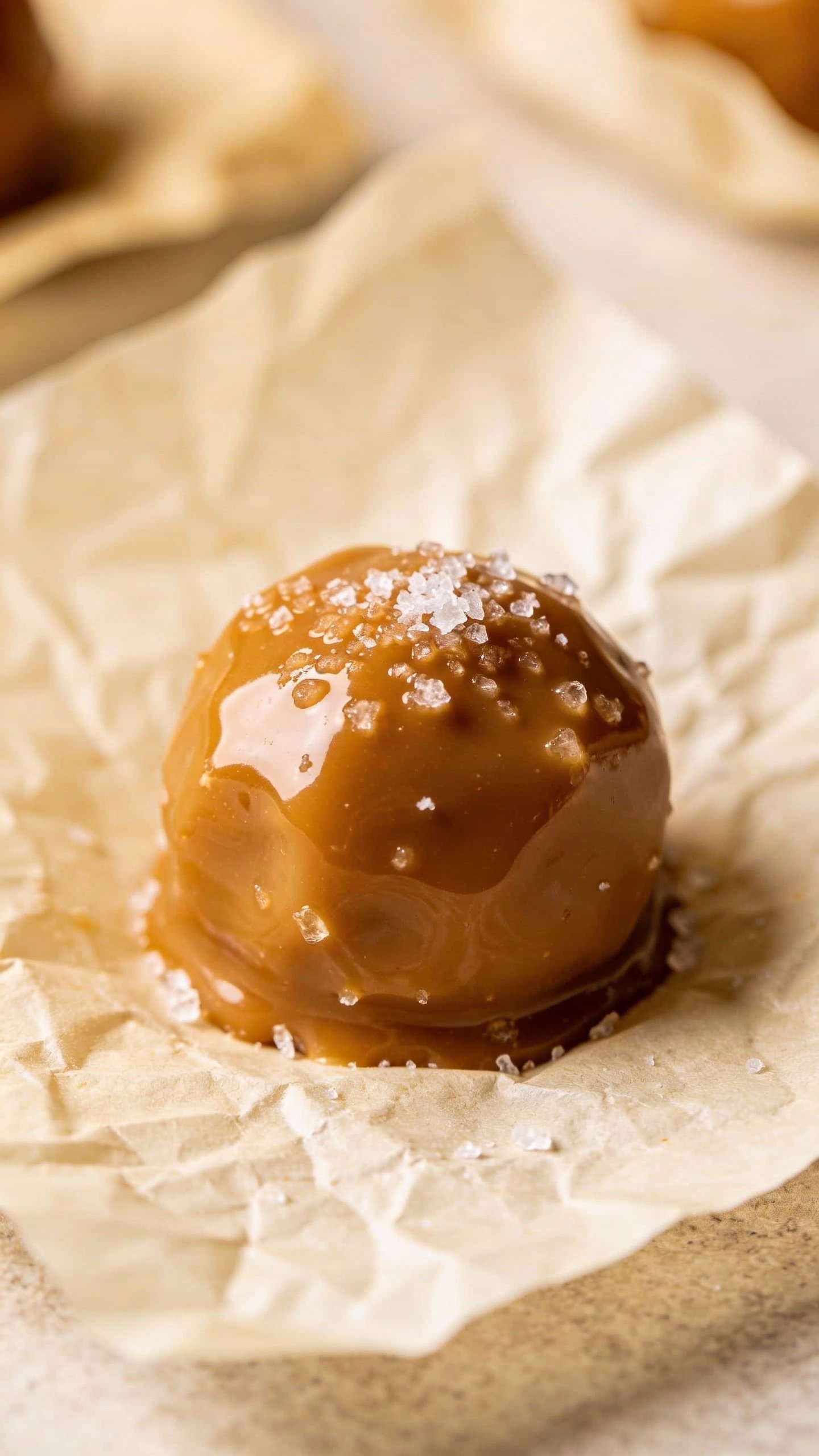 closeup salted caramel keto fat bomb on parchment