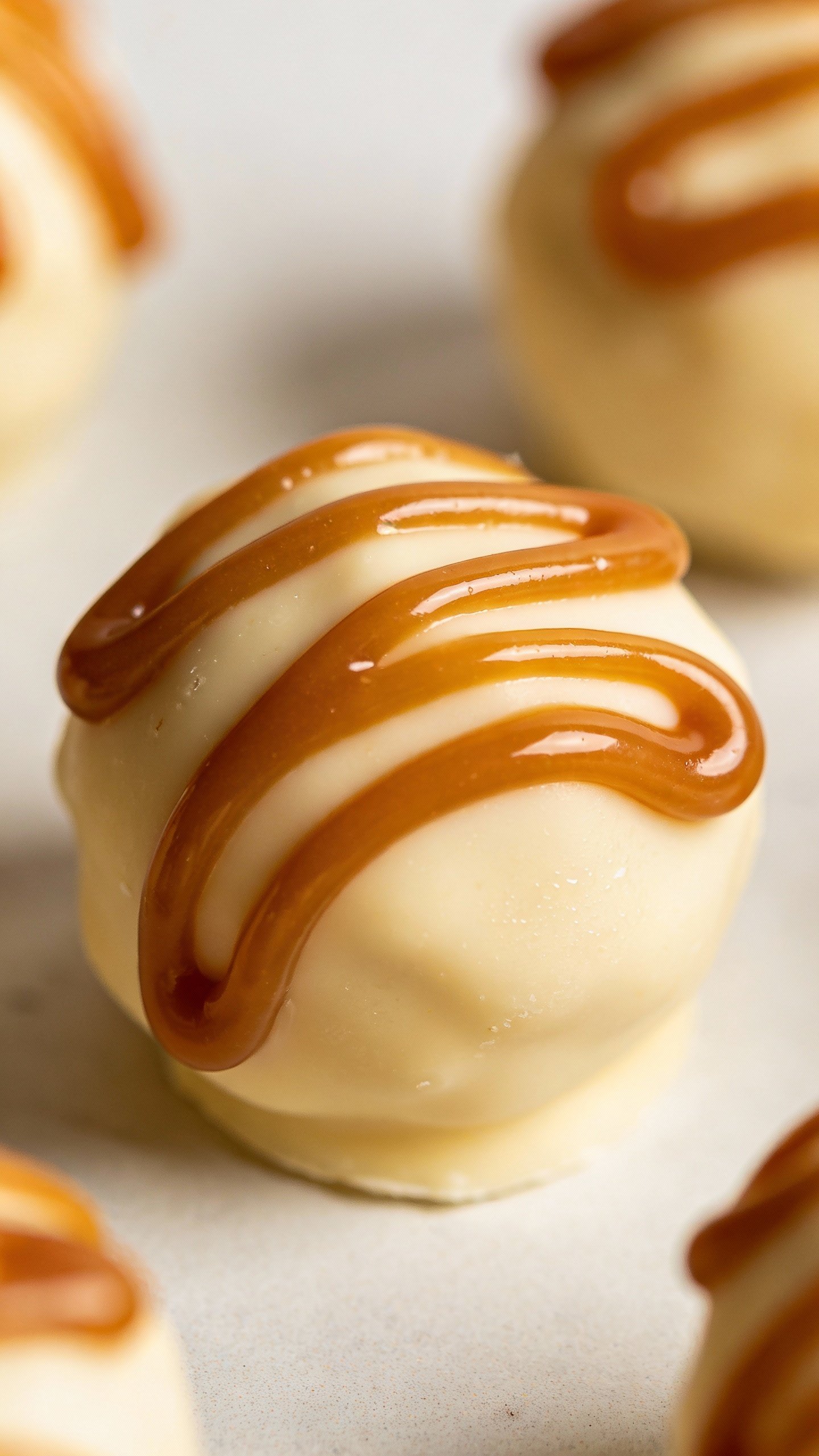 creamy caramel keto fat bomb bite with glossy swirl