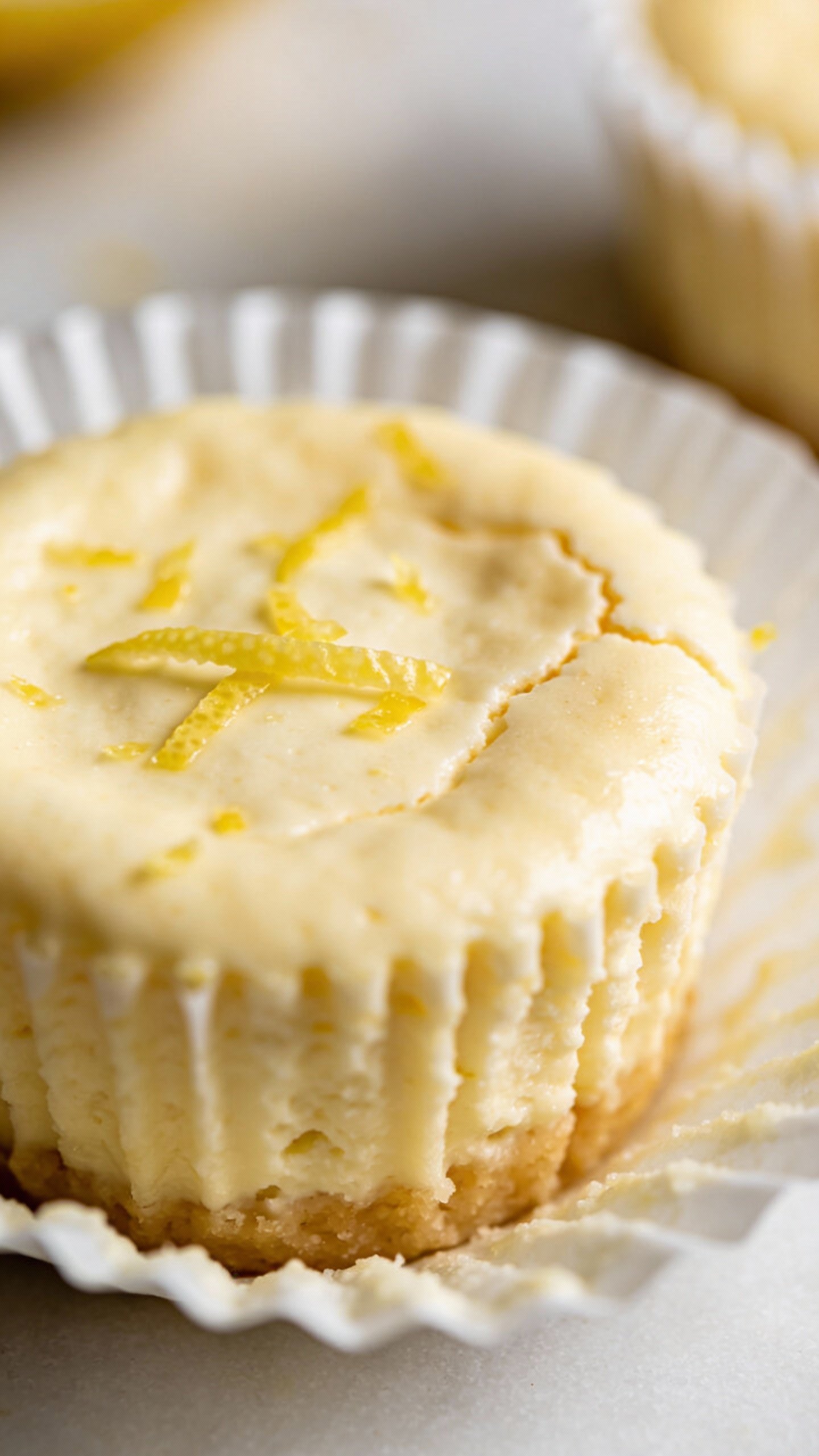 closeup keto lemon cheesecake cup in white muffin liner