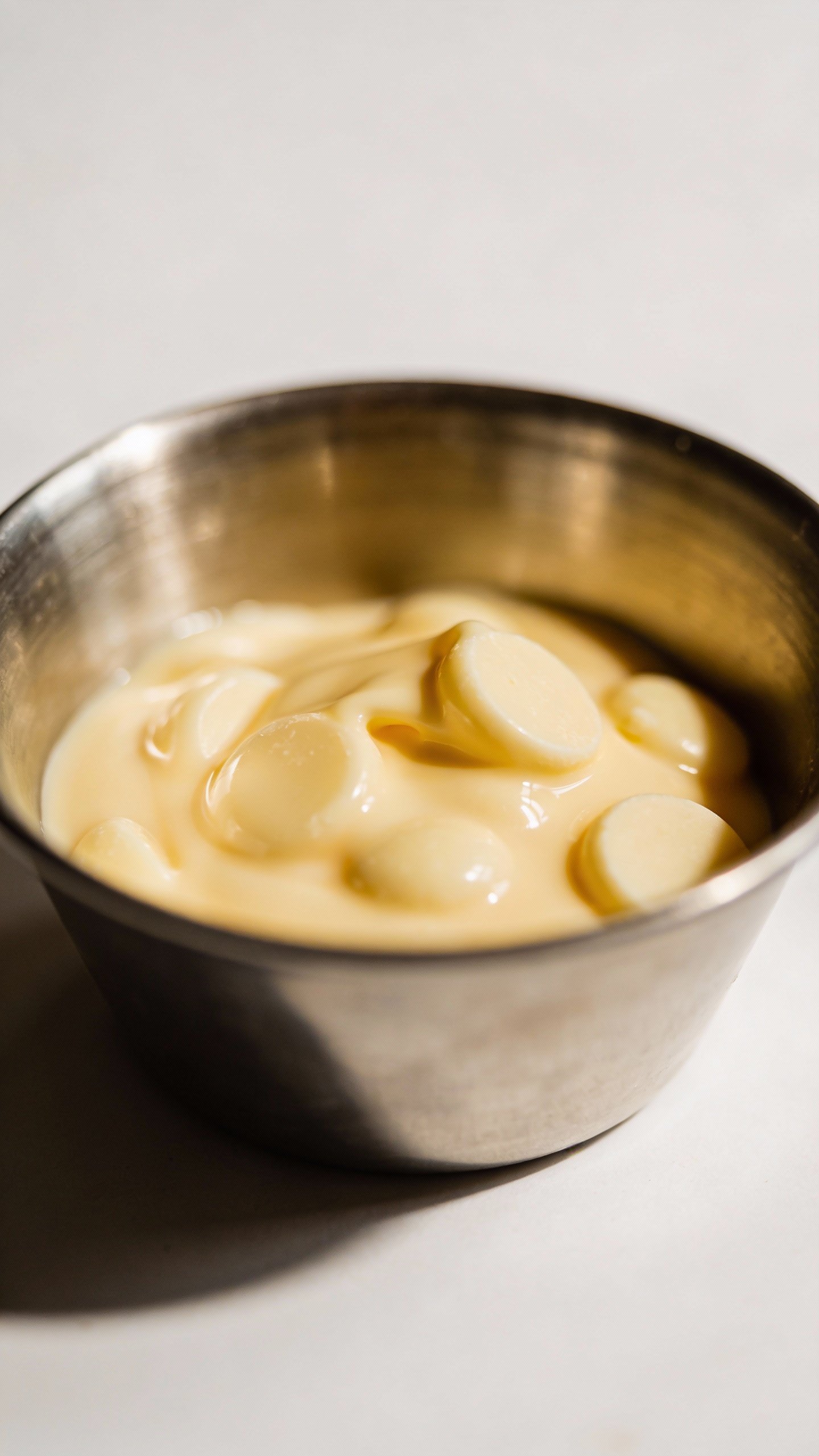 melted sugar-free white chocolate chips in small stainless bowl