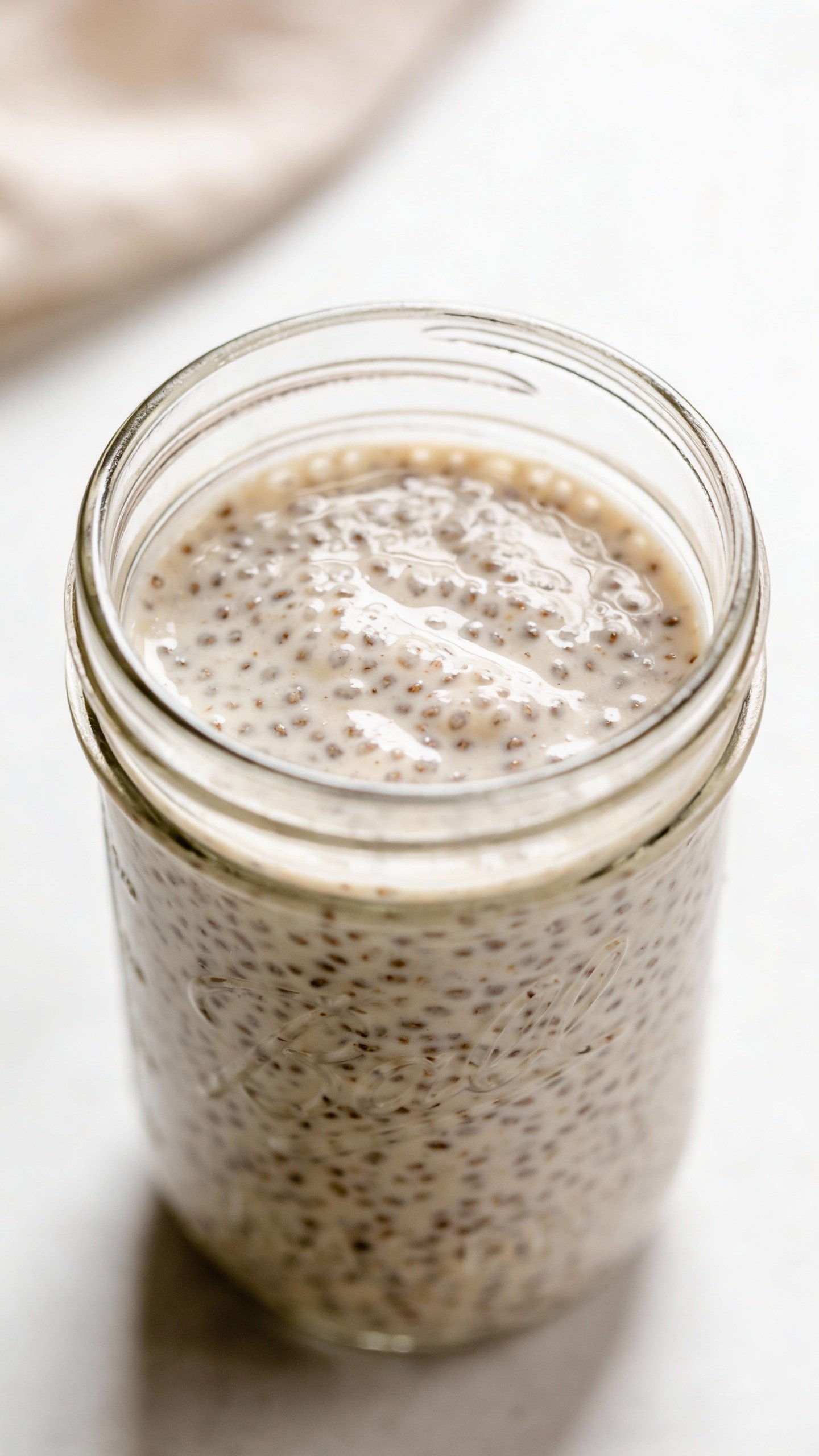 closeup keto vanilla chia pudding in clear jar, overhead