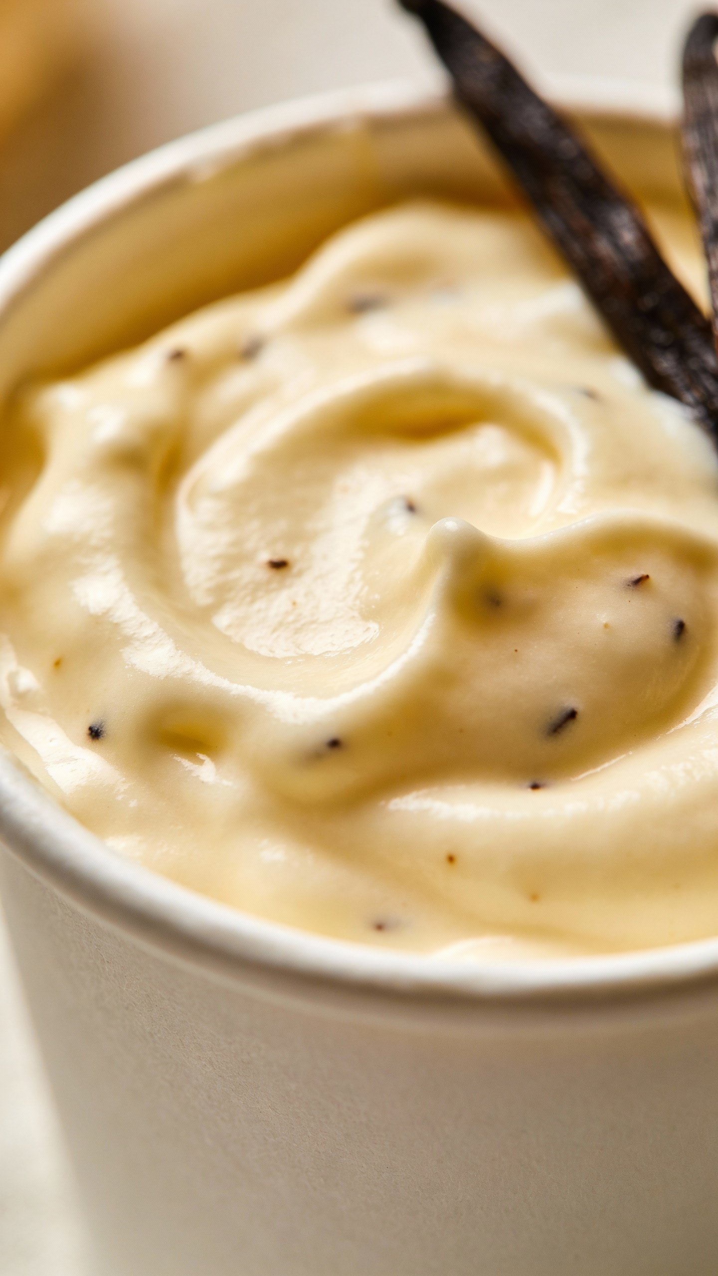 closeup keto vanilla cream dessert cup with vanilla bean specks