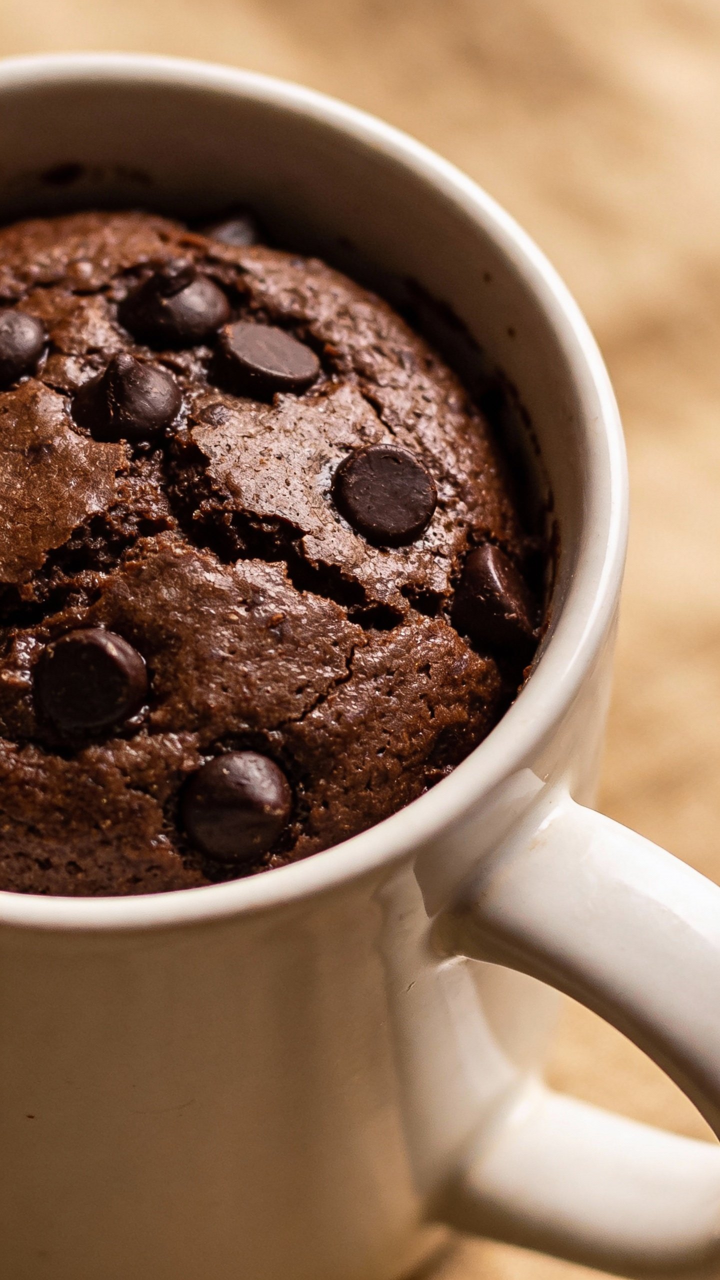 Keto chocolate chip mug cake in white ceramic mug, closeup