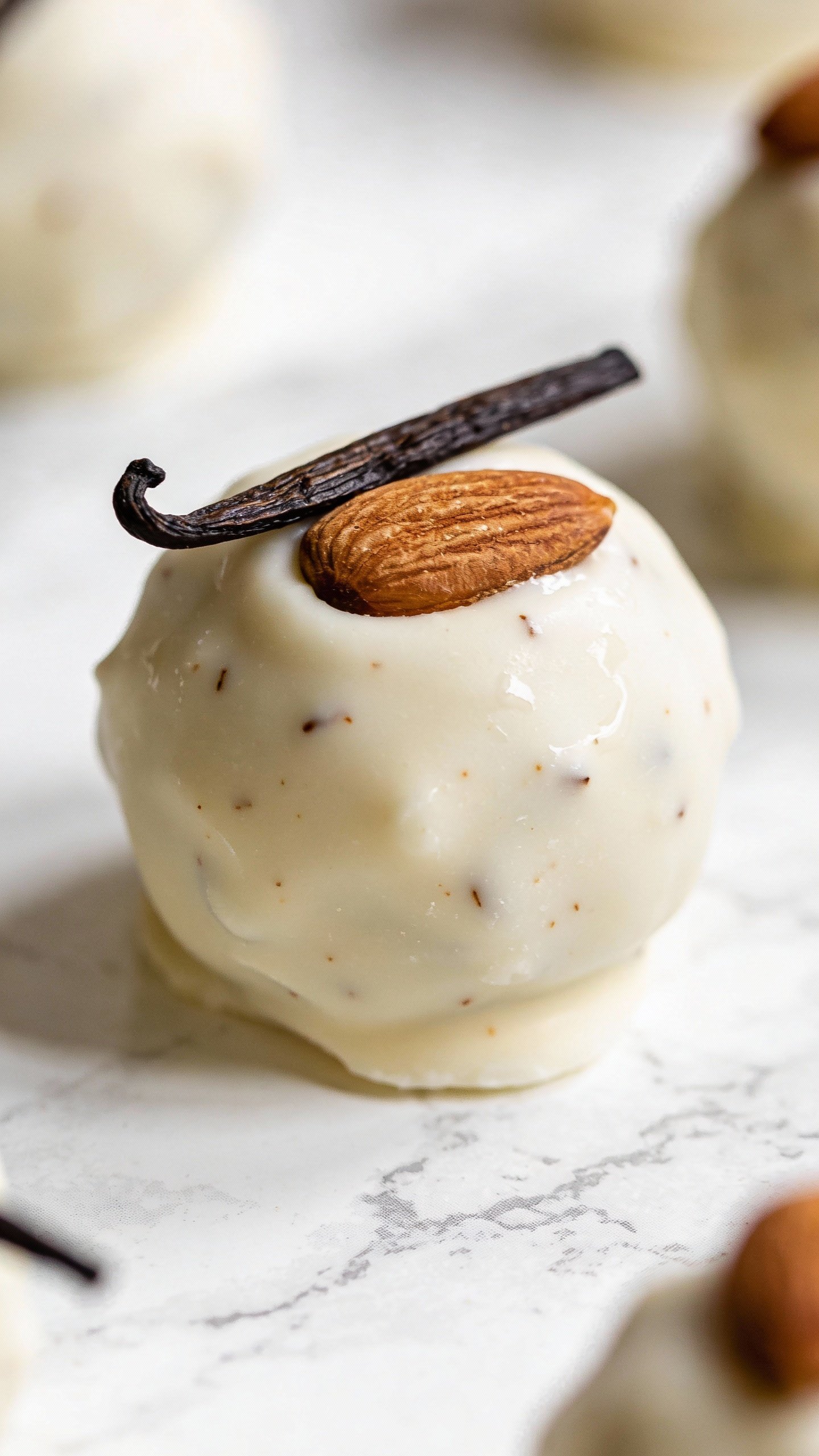 closeup keto vanilla almond fat bomb on white marble