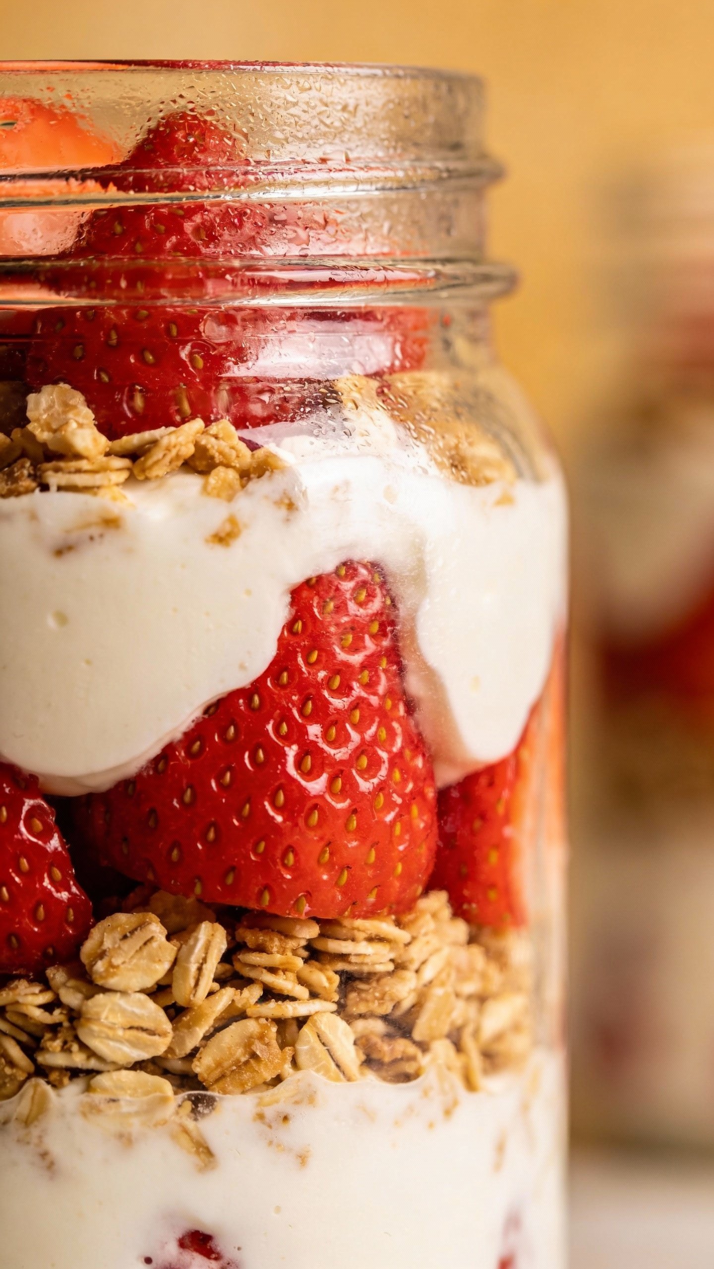 closeup keto strawberry cream parfait in clear glass jar