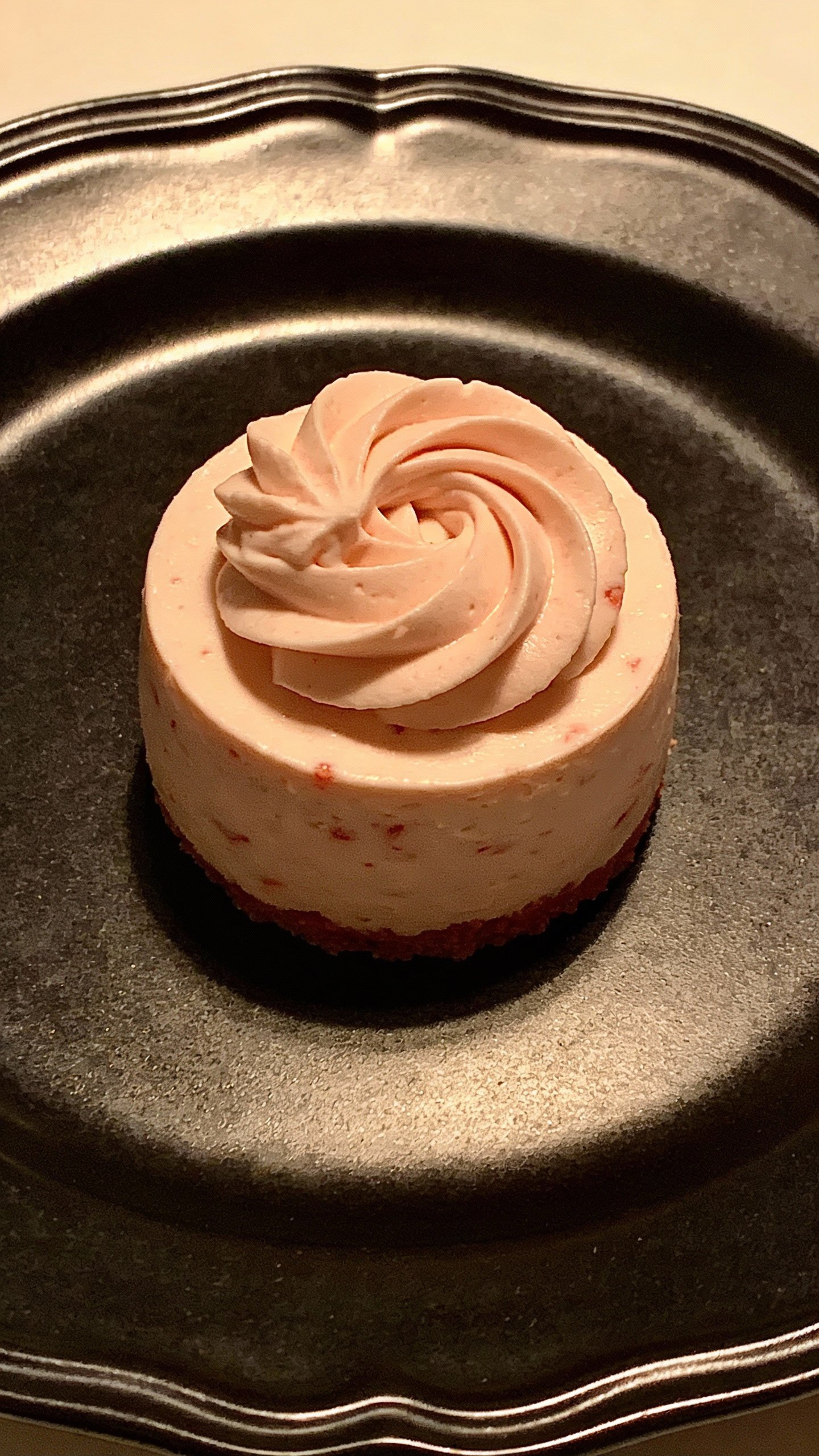 single strawberry cheesecake fat bomb with swirl, matte black plate