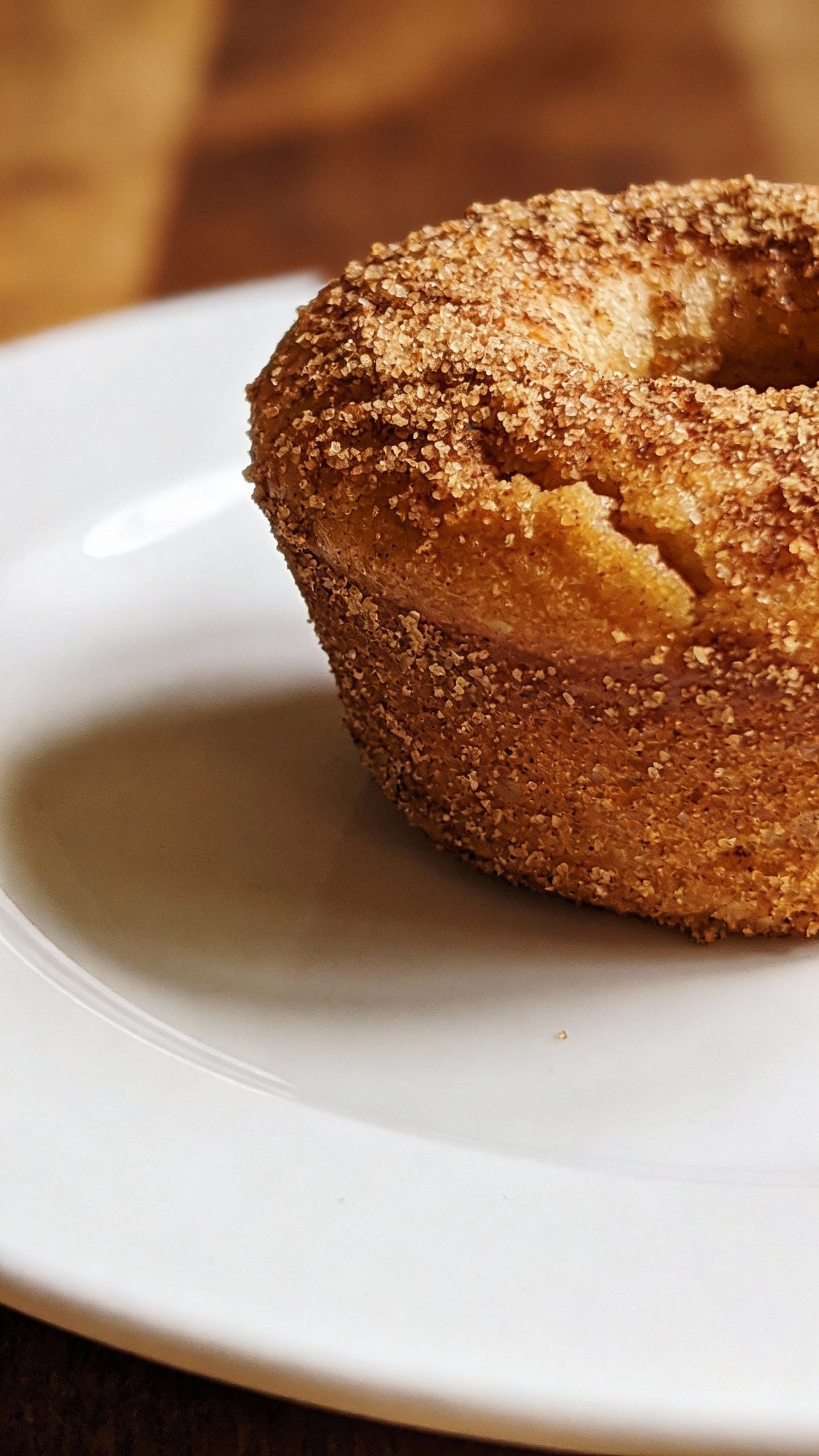 closeup keto cinnamon sugar donut muffin on white plate