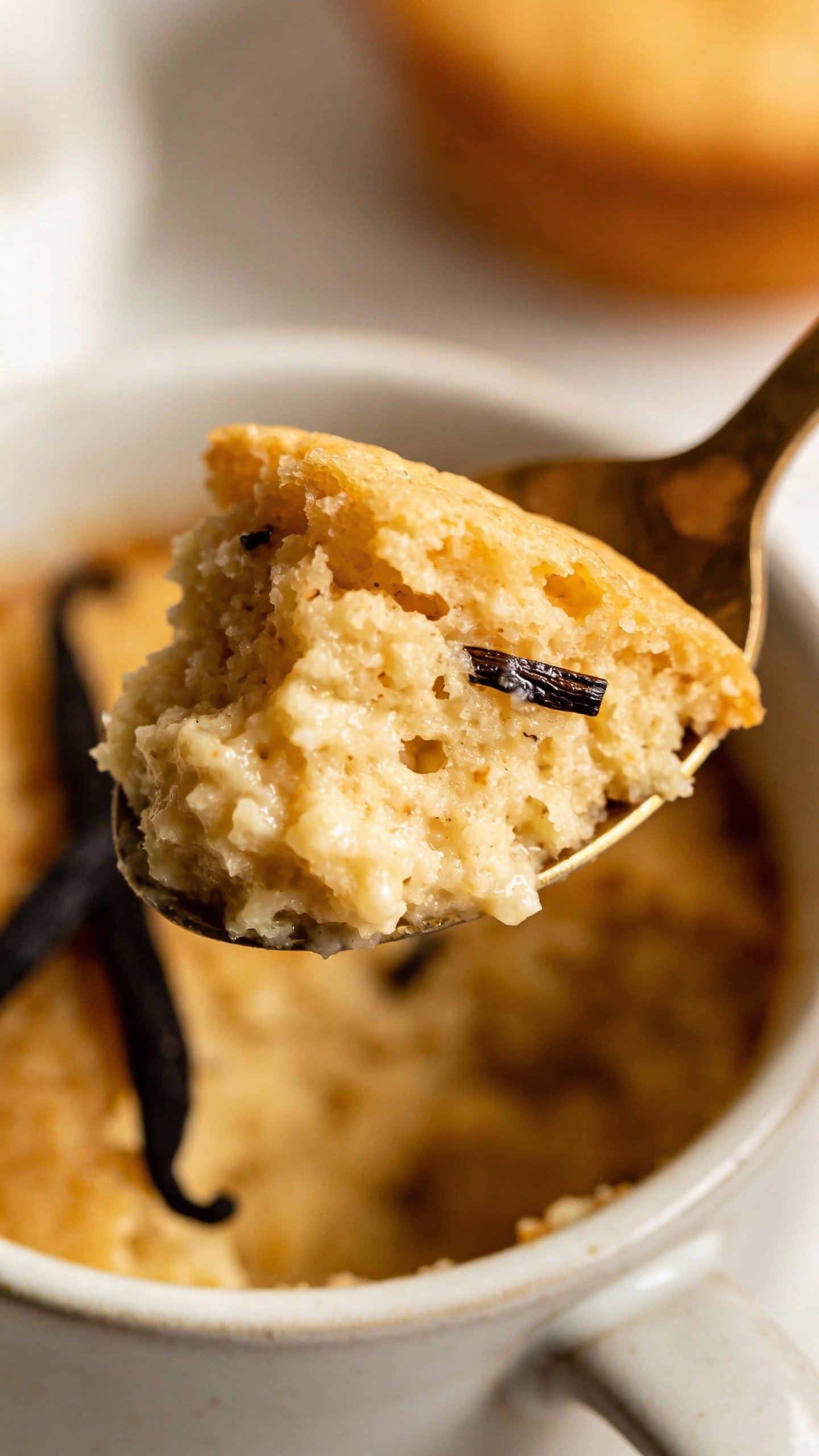 spoonful of warm keto vanilla mug cake with visible bean specks