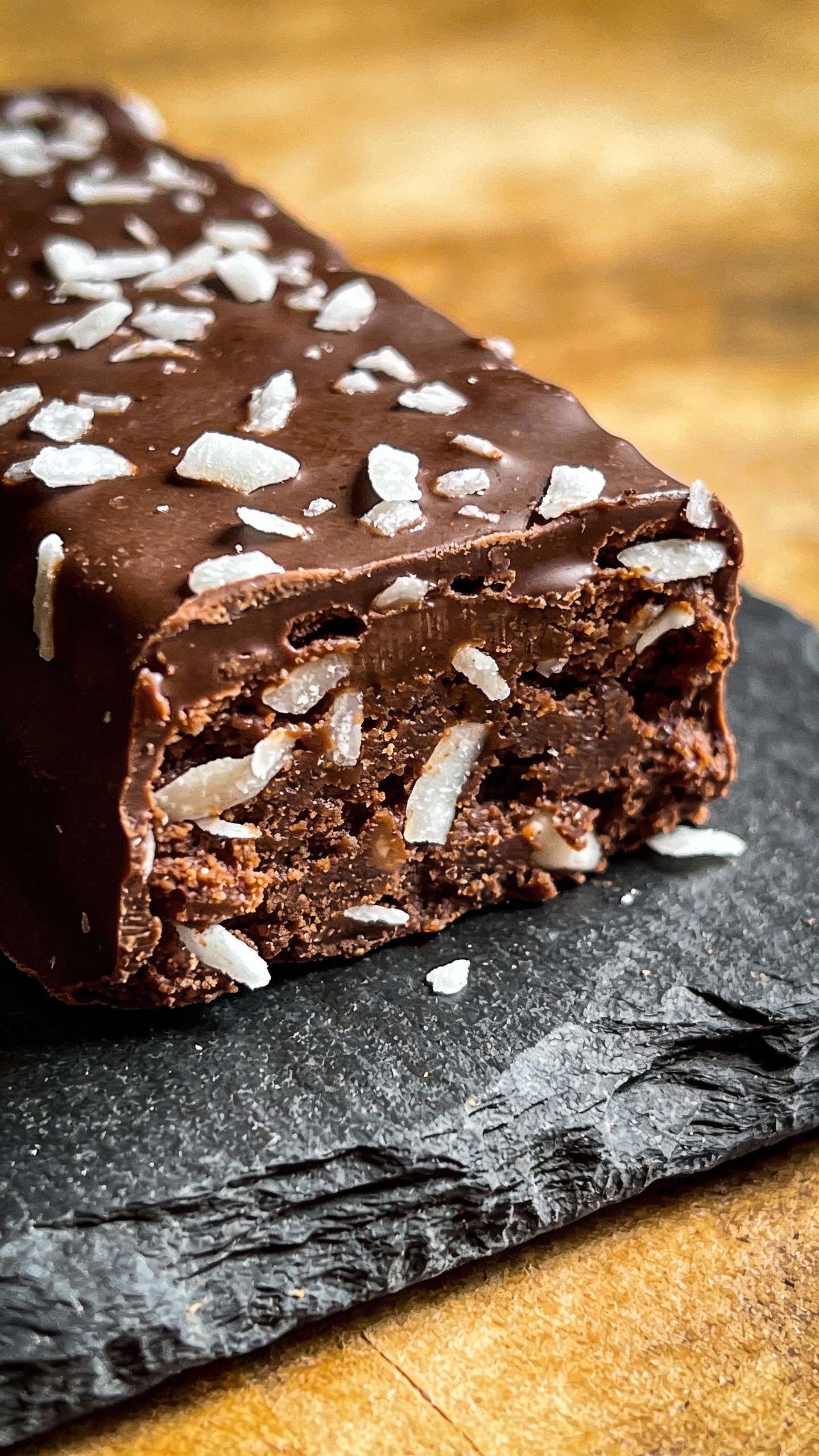 closeup keto chocolate coconut truffle bar on slate board