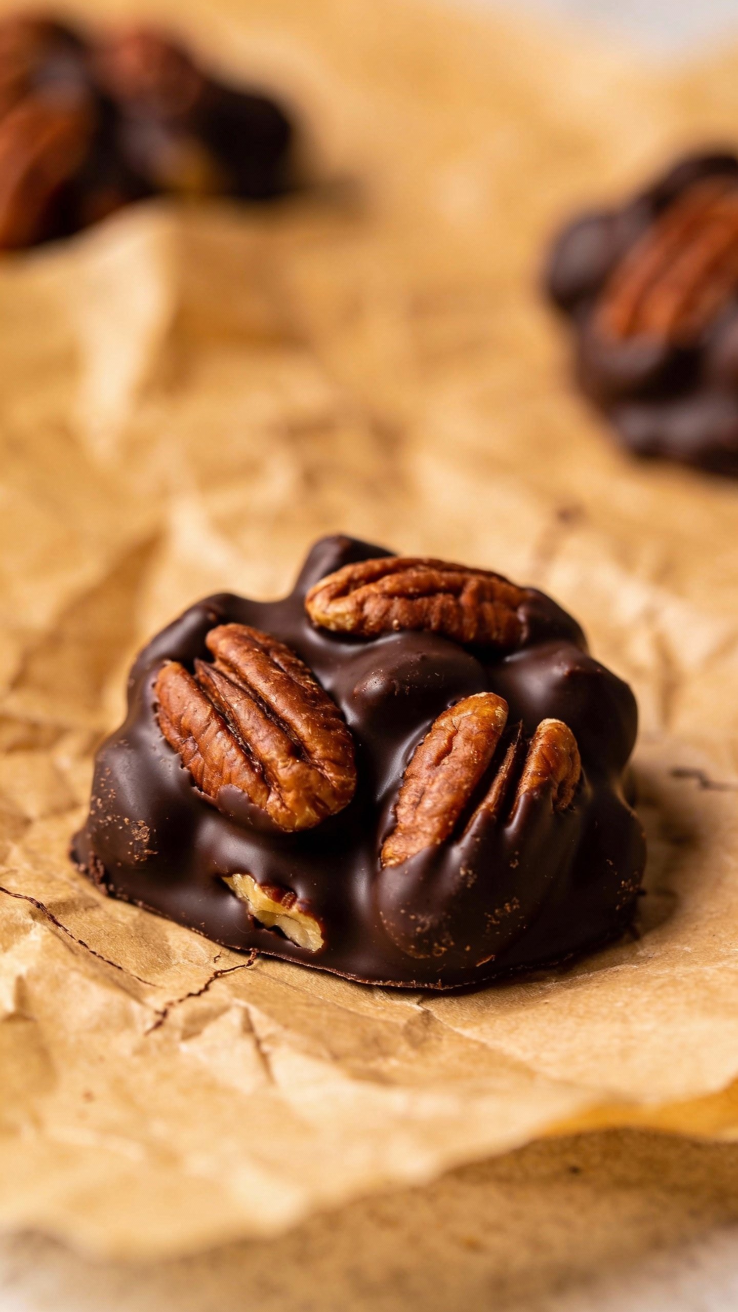 closeup of keto chocolate pecan cluster on parchment