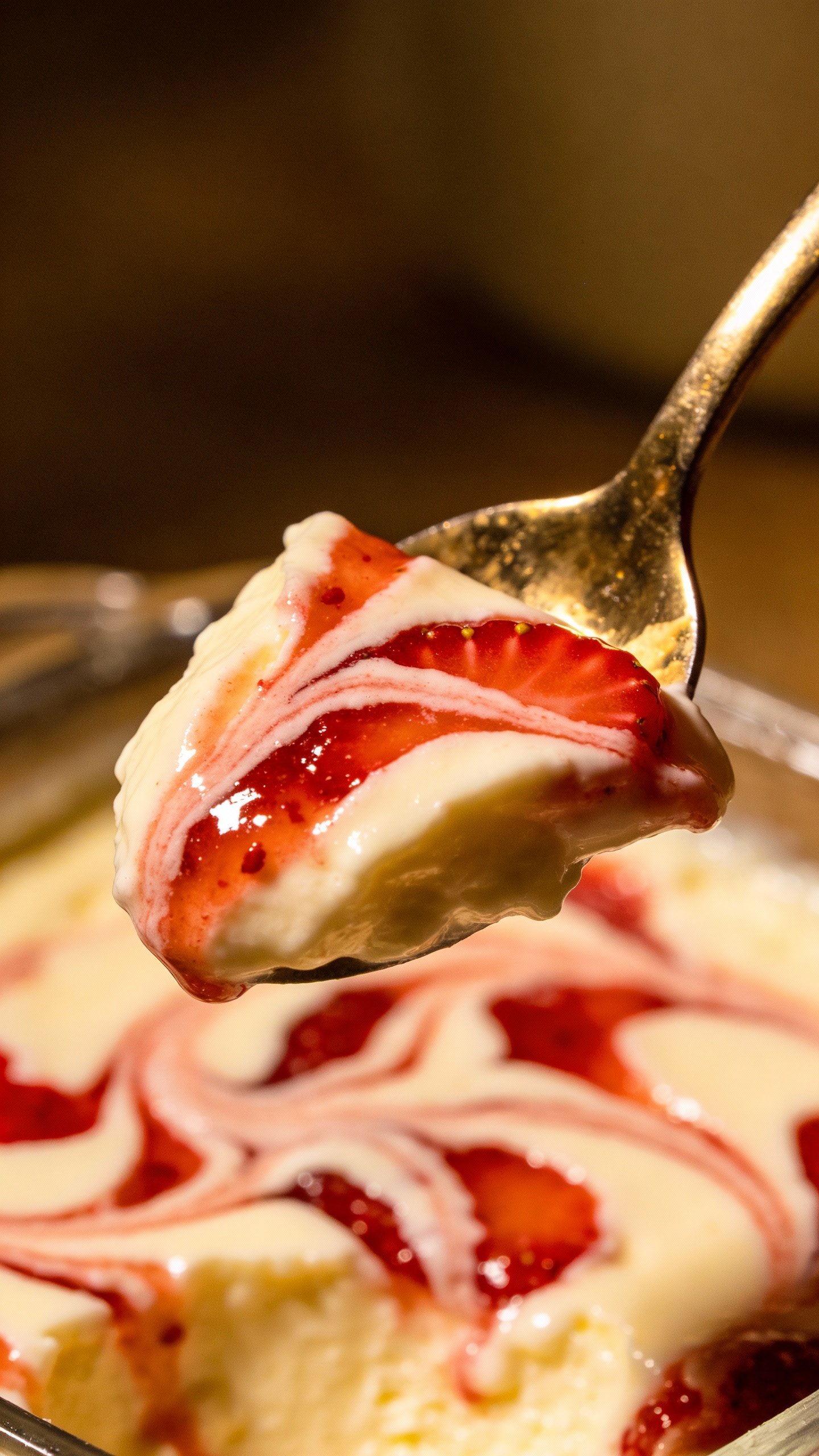 spoonful of strawberry swirl cheesecake, creamy texture detail