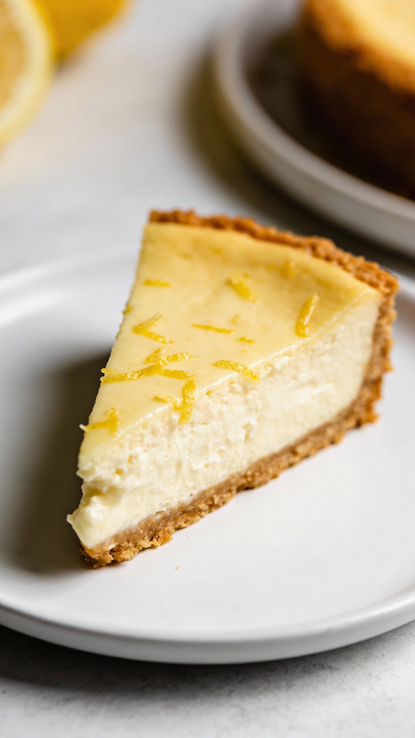 keto lemon cream cheesecake slice on white plate, closeup
