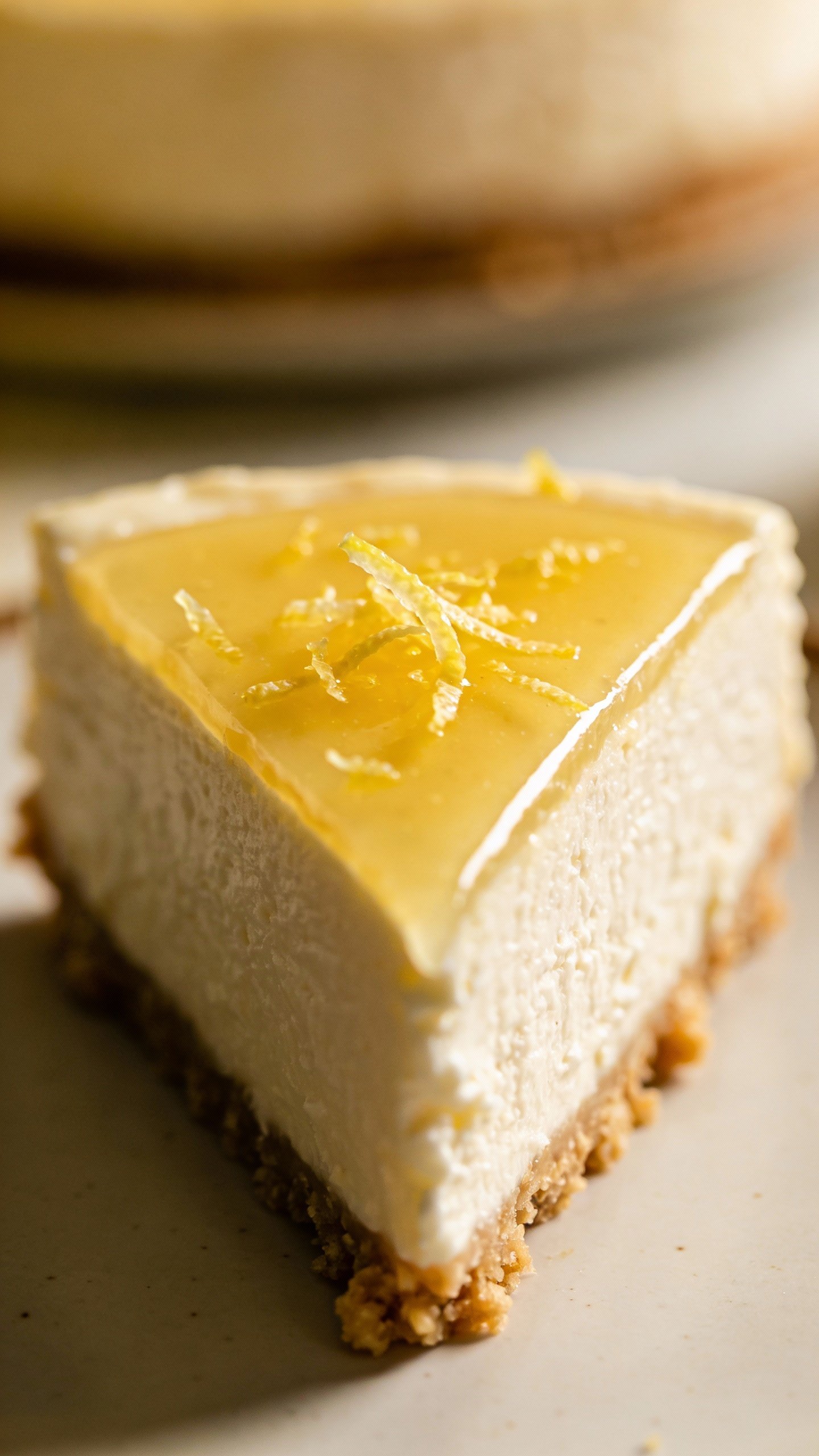 single keto lemon cheesecake with lemon zest garnish, closeup