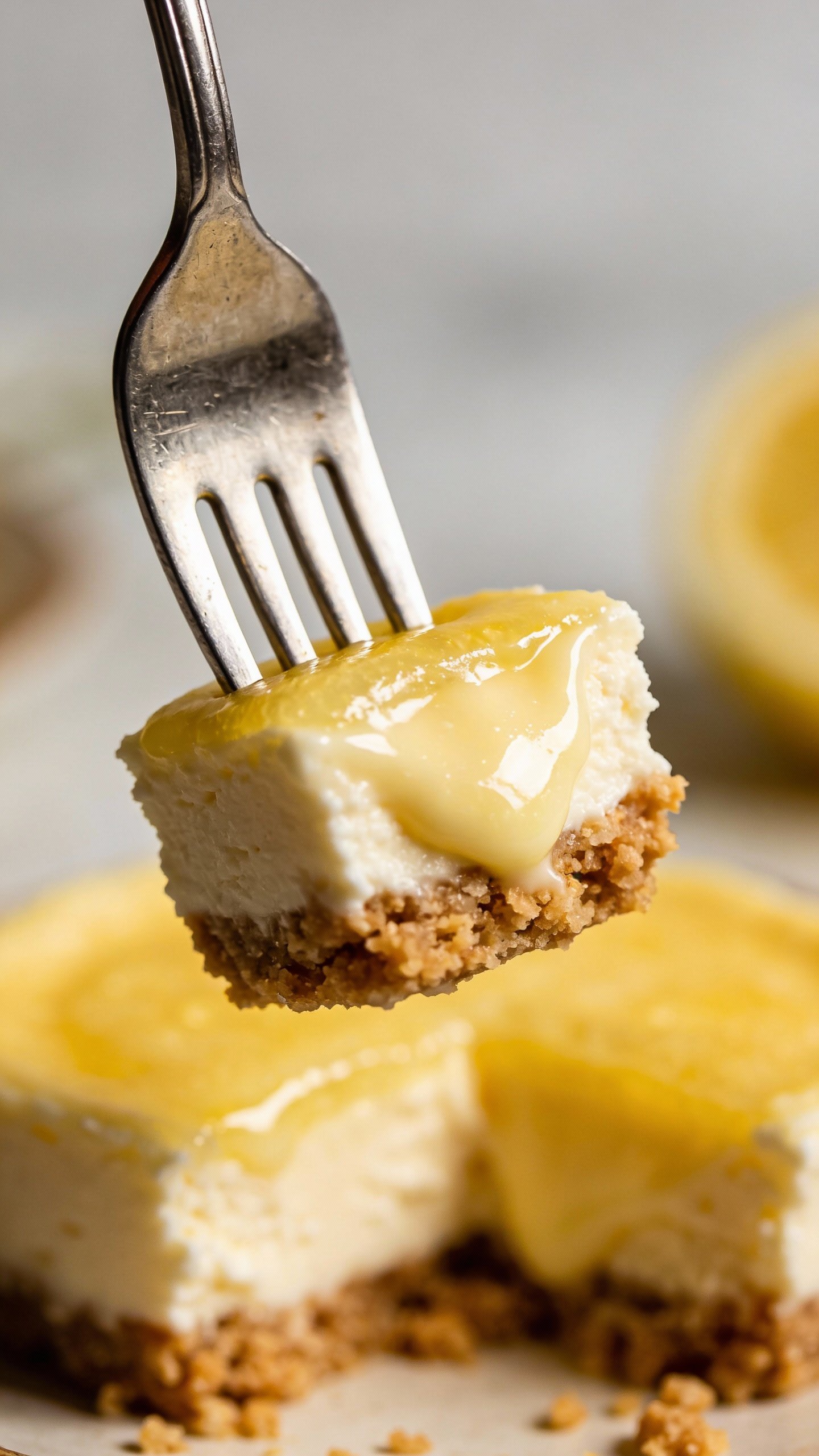 keto cheesecake bite on silver fork, creamy lemon filling, closeup