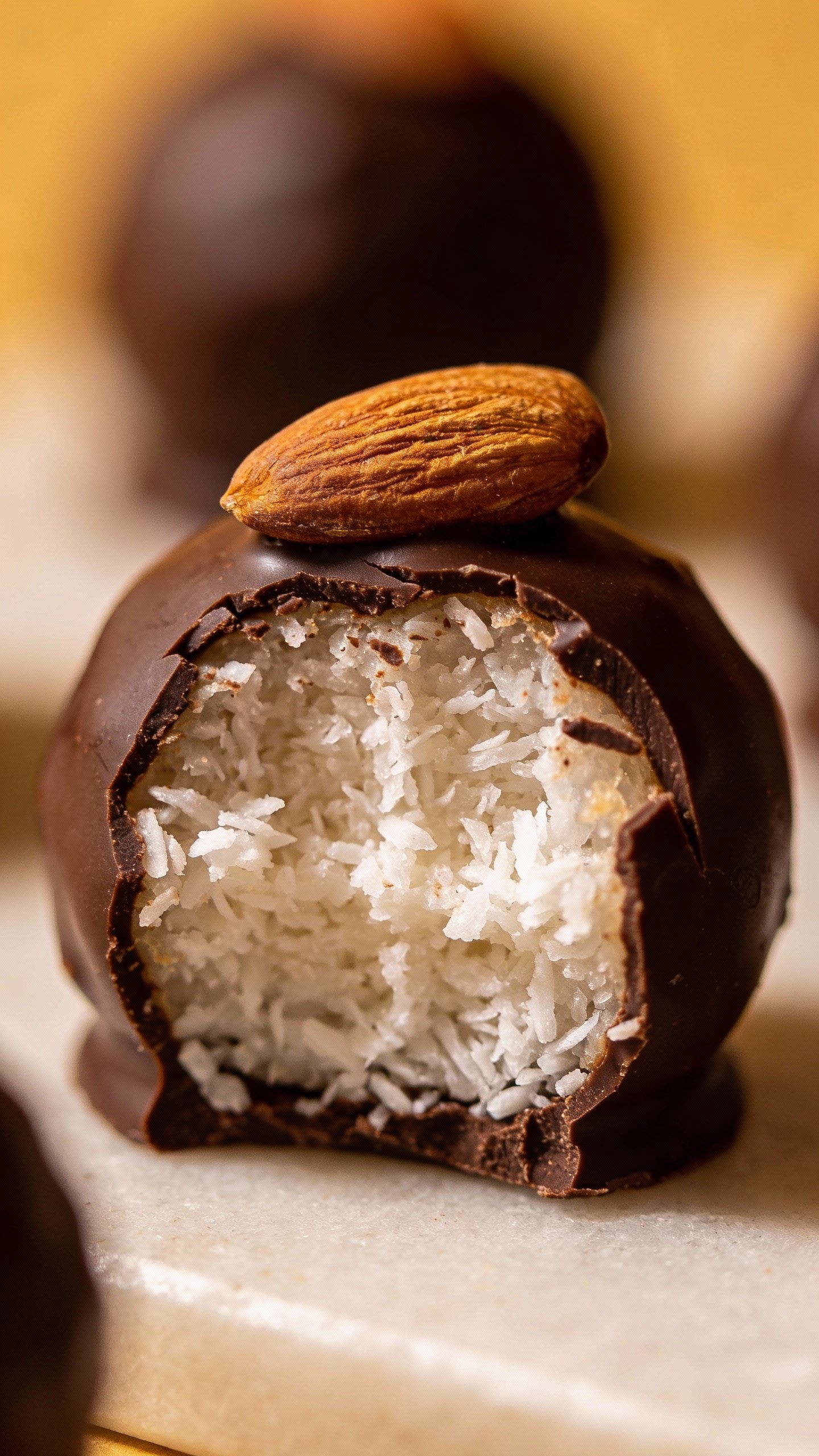 single coconut-filled chocolate fat bomb with almond on top