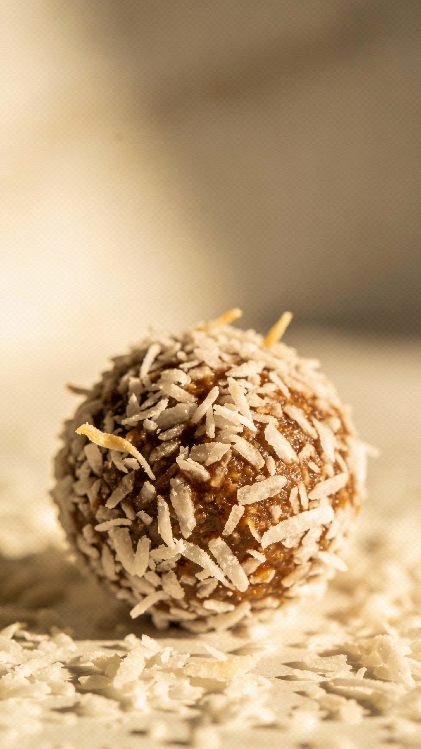 single bliss ball rolled in shredded coconut, macro shot