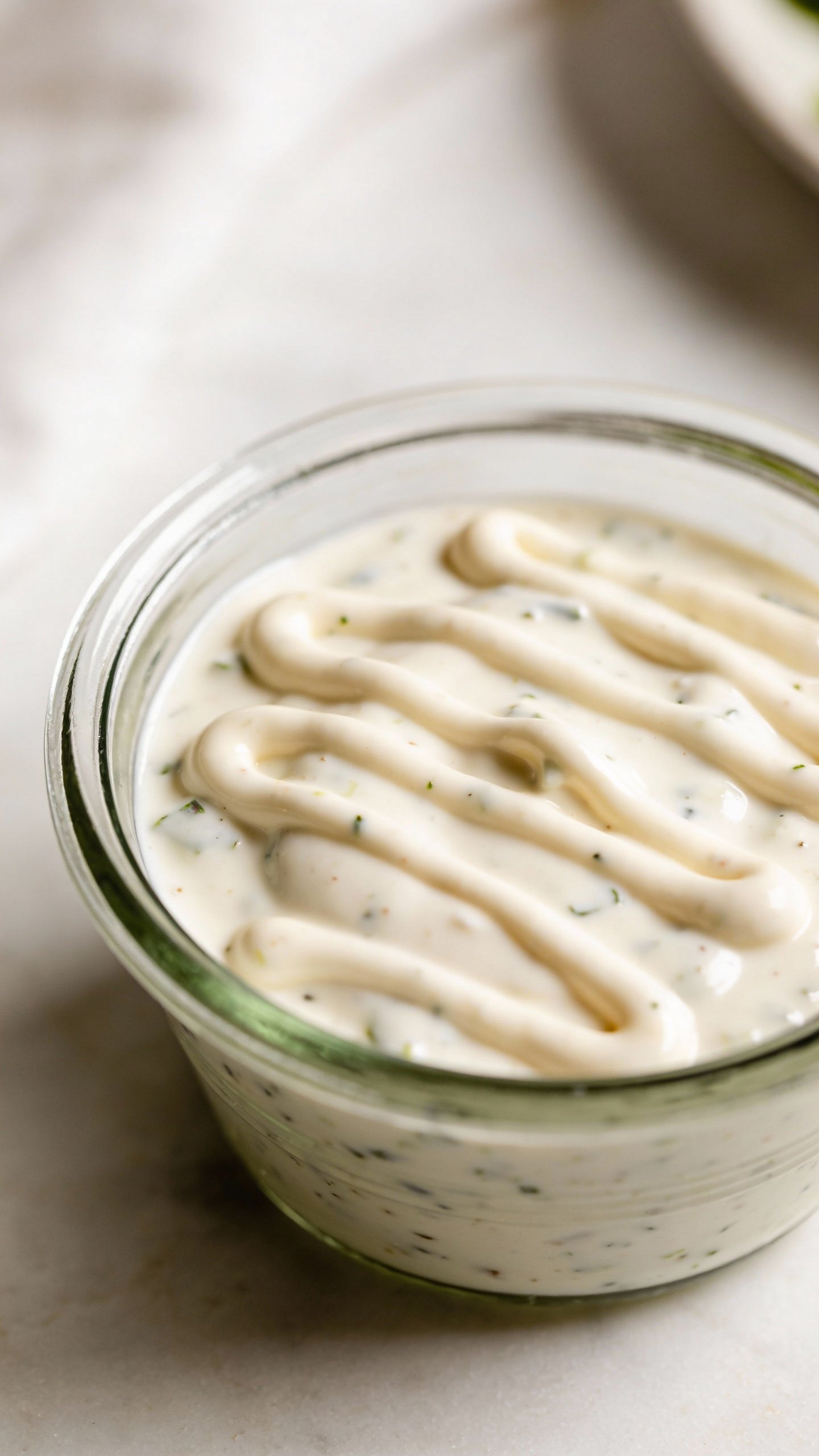 glass ramekin of sugar-free ranch dressing, drizzled and creamy