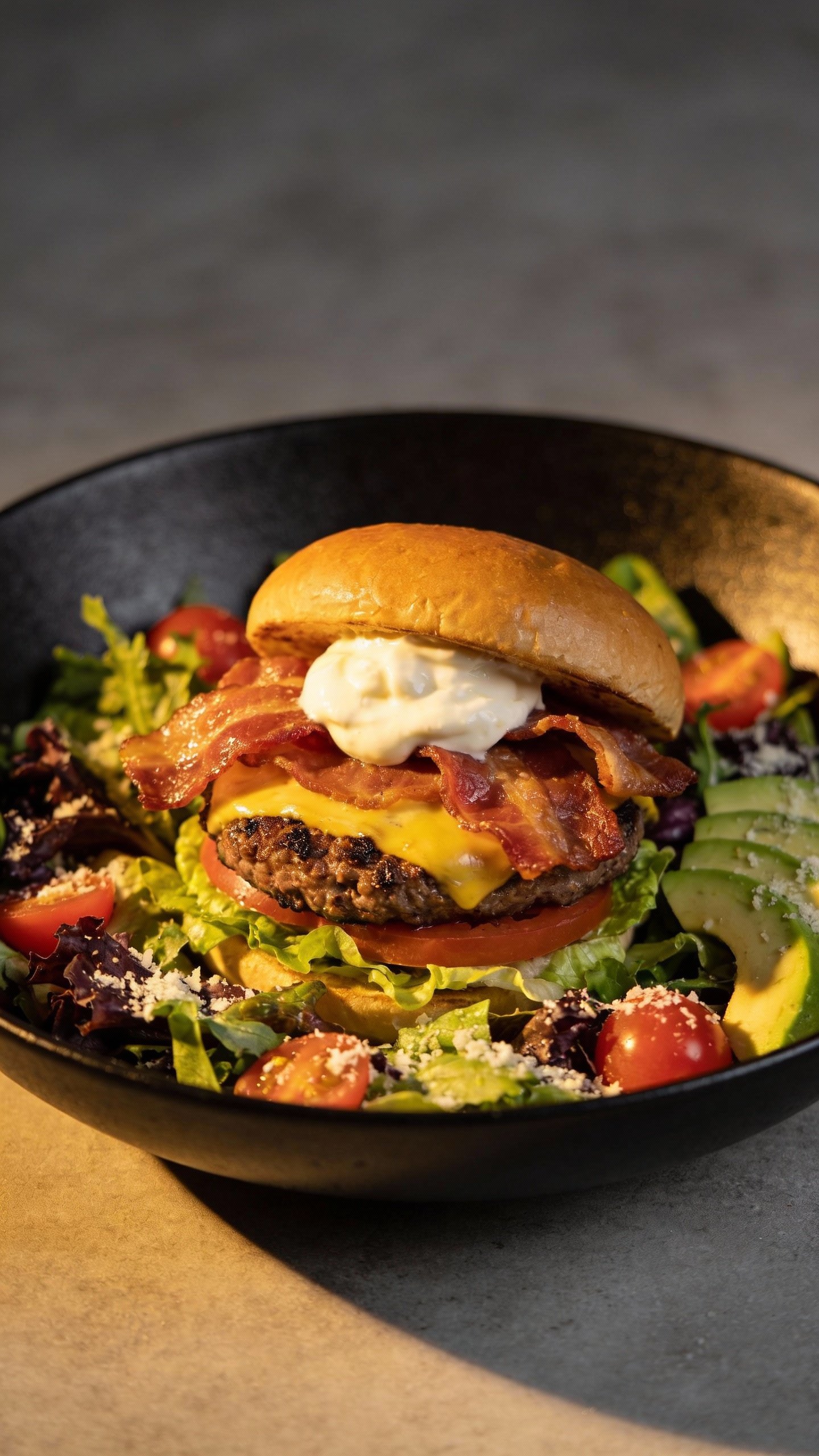 closeup bacon cheeseburger keto salad in black bowl
