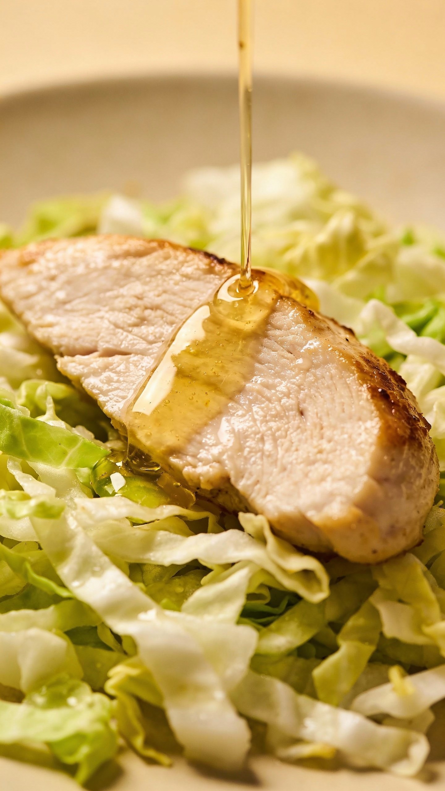 single chicken breast slices on shredded cabbage, ginger-lime drizzle