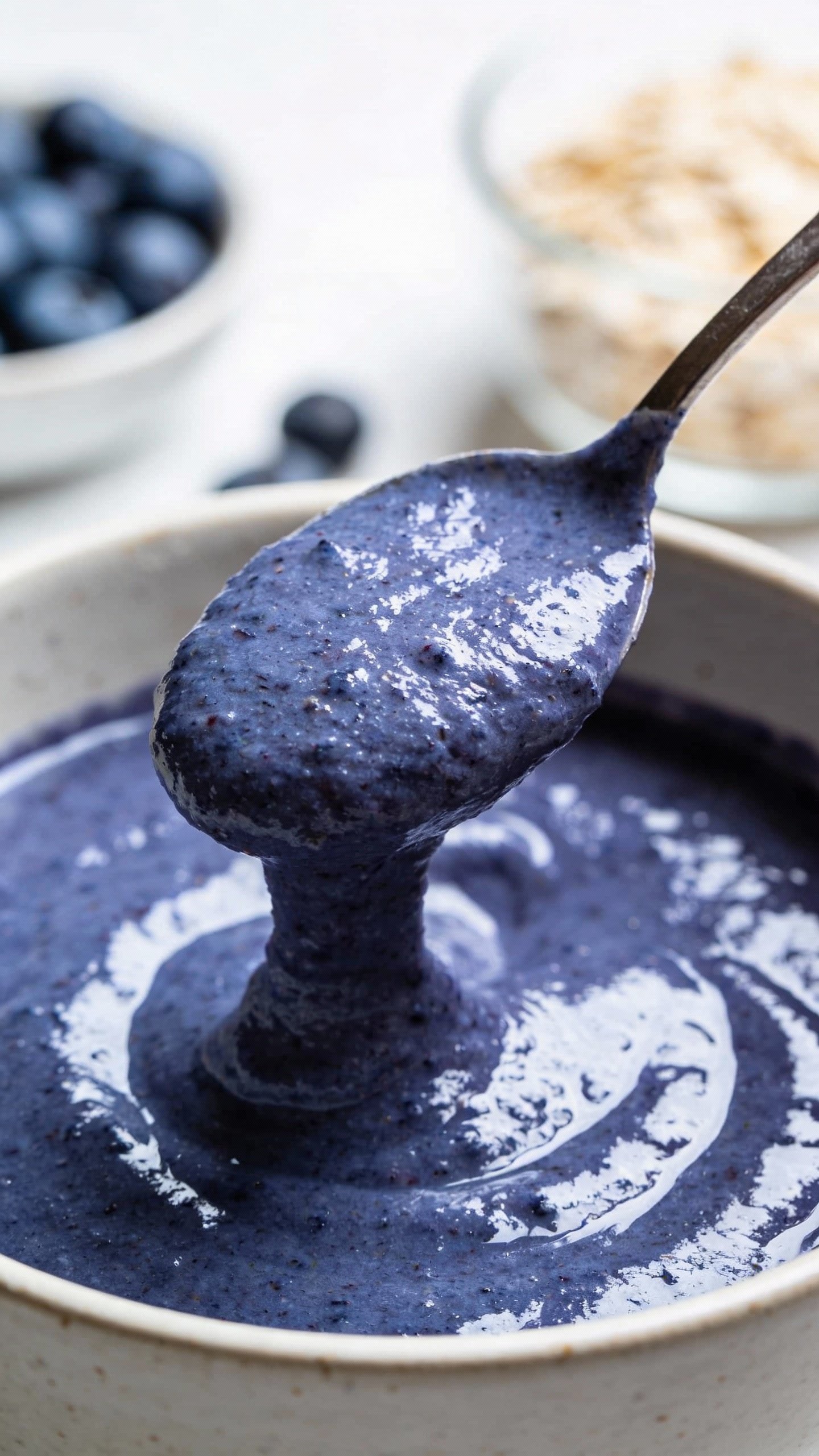 spoonful of blended blueberry oat smoothie, creamy texture