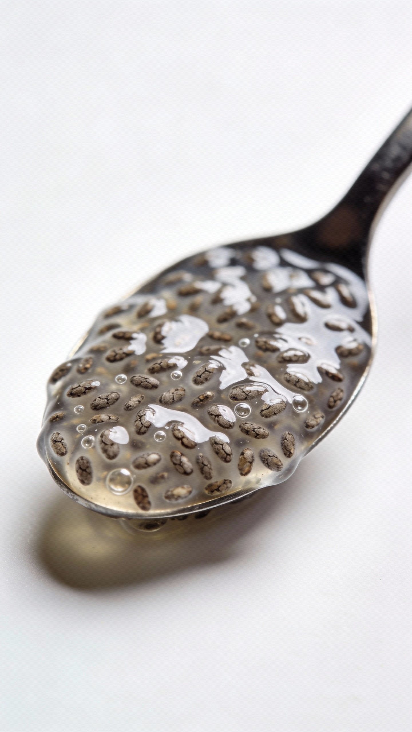 spoonful of soaked chia seeds against white background