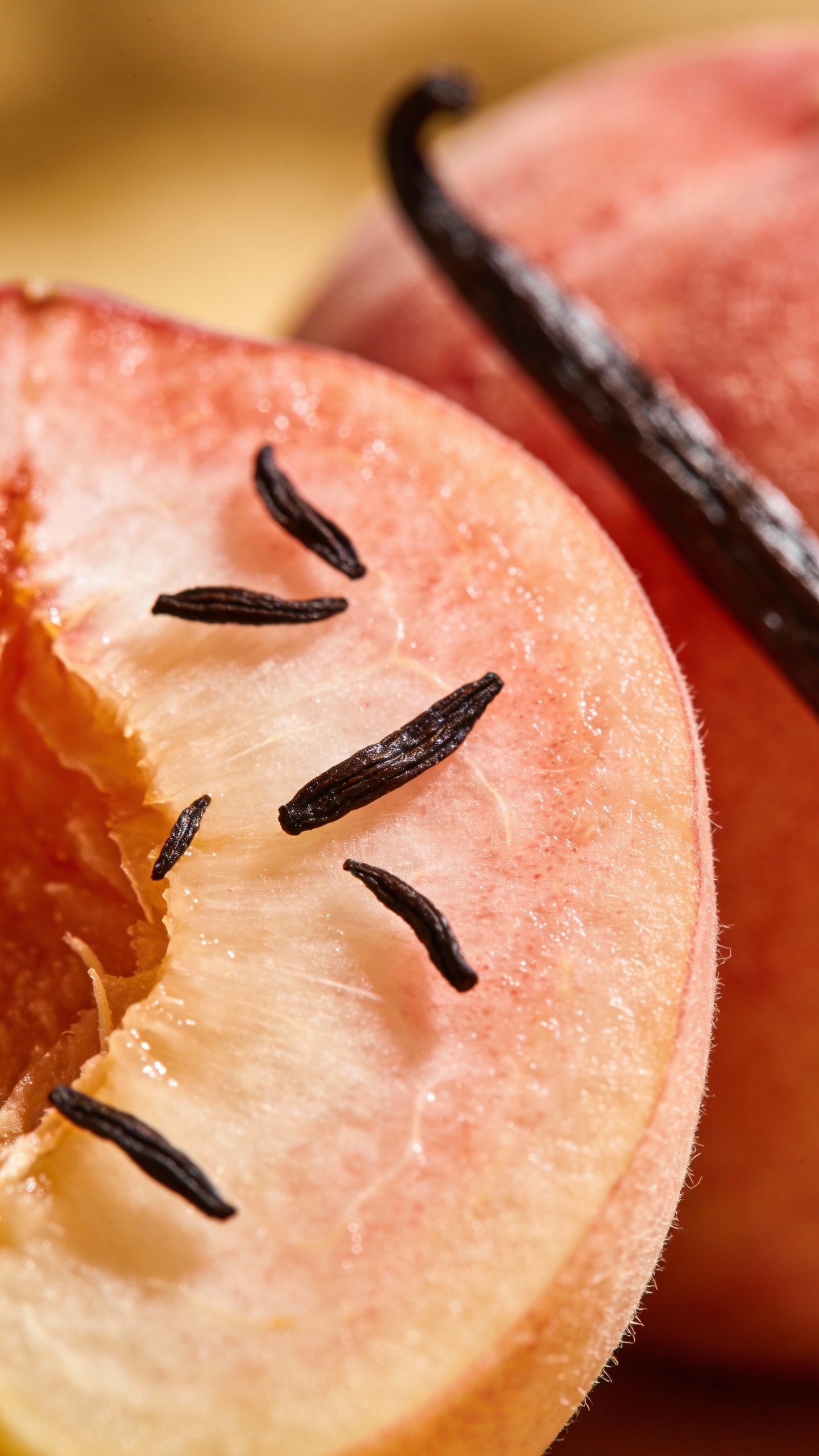 single ripe peach half with vanilla bean seeds, macro shot