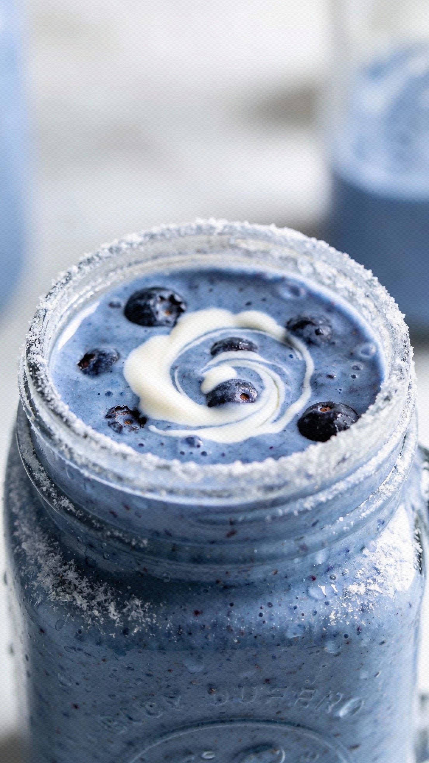 frosty blender jar with blueberry vanilla smoothie, creamy swirl