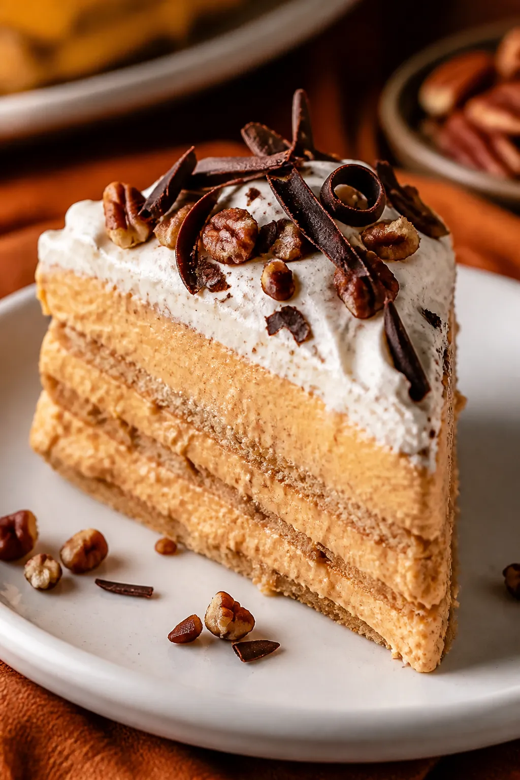 Close-up detail of a single plated slice of the pumpkin icebox cake on a white ceramic dessert plate