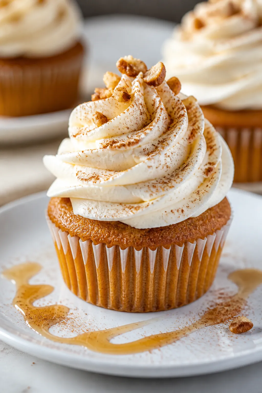 Close-up final presentation of a keto pumpkin cupcake generously piped with silky cinnamon cream che