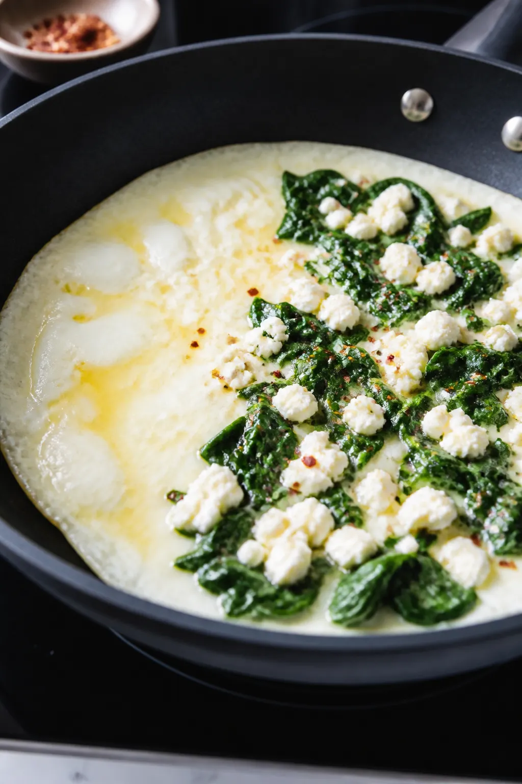 Cooking process close-up: Egg white omelet just before folding in a 9-inch nonstick skillet over med