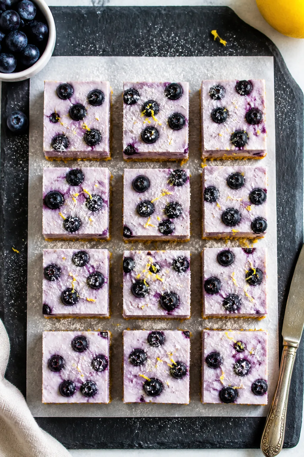 Overhead final presentation: Clean slices of Low Carb Blueberry Cottage Cheese Bars arranged in a ne