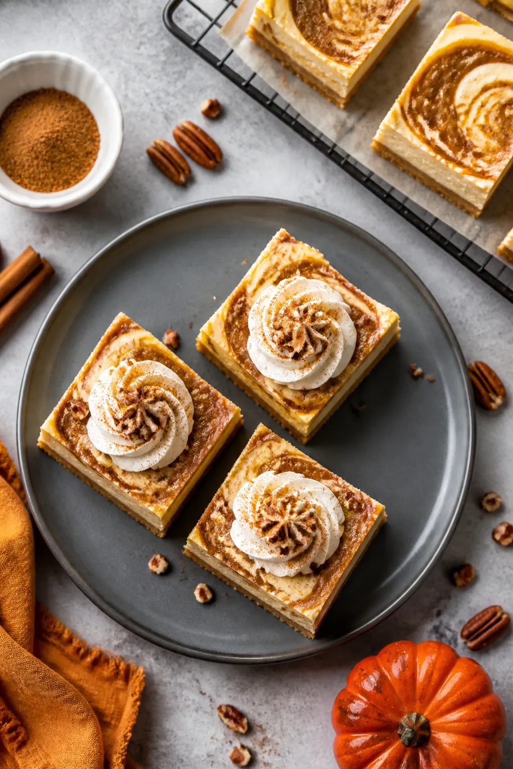 Overhead final presentation: Tasty of a slate-gray plate holding three Keto Pumpkin Butter Cheesecak