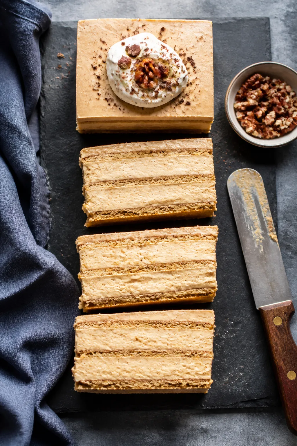 Overhead shot of a chilled Low Carb Pumpkin Icebox Cake just lifted from an 8x8 pan using parchment 