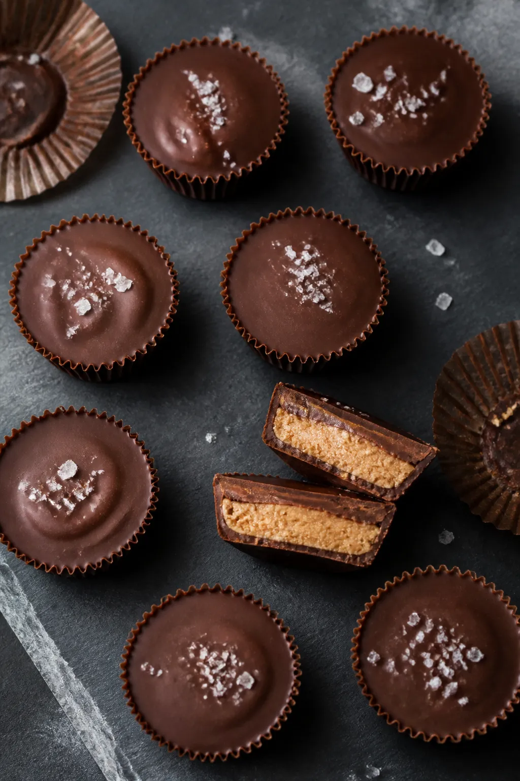 Overhead shot of finished low-carb chocolate peanut butter cups just set and unwrapped, arranged in 